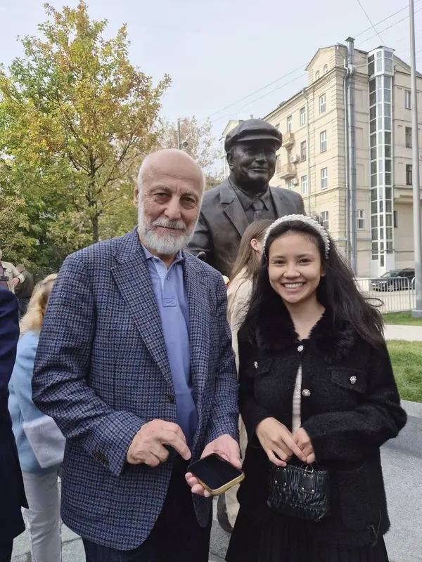 Meeting a local resident next to a bronze statue in Russia