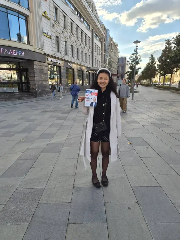 Holding a document on a pedestrian street in Russia